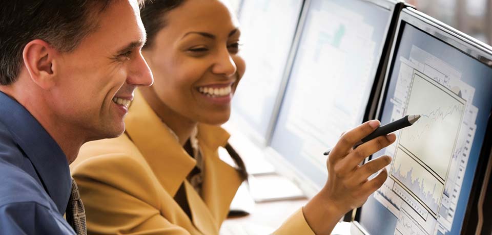 Two people reviewing information on a computer screen