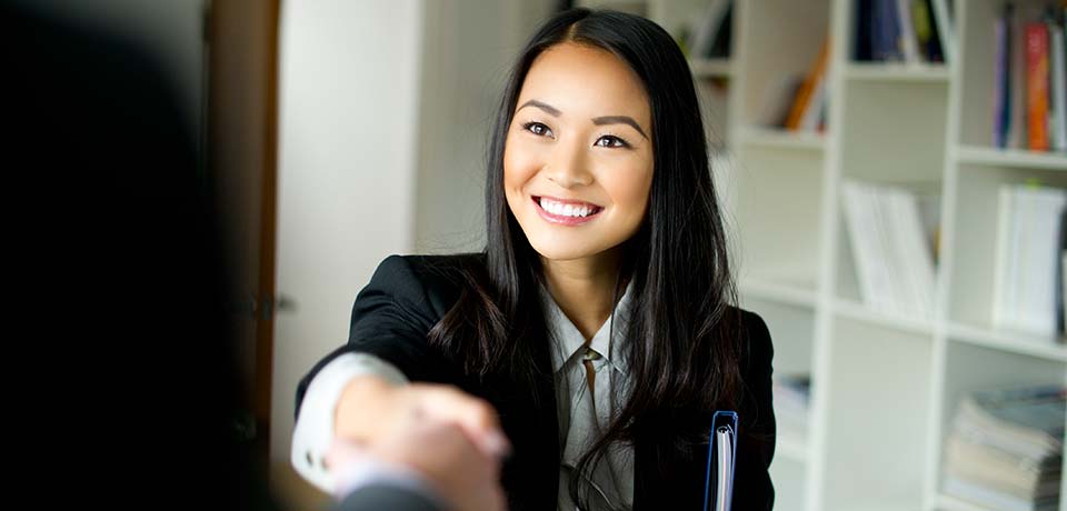 A woman shaking a mans hand after a job interview